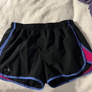 Under Armour athletic shorts. Main color is black with pink and purple on sides.